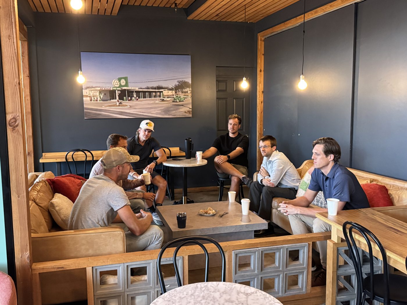 Men in conversation inside a coffee shop